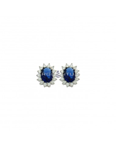 Lobe earrings 10.5x13 mm with central oval blue zircon in a frame of white zircons plated white gold in 925 silver