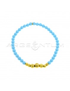 Elastic bracelet with turquoise paste spheres, degradè transversal diamond side spheres and yellow gold plated shiny central sphere in 925 silver