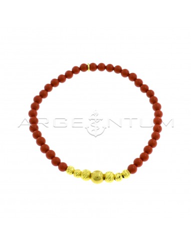 Elastic bracelet with coral paste spheres, degradè transversal diamond side spheres and yellow gold plated shiny central sphere in 925 silver