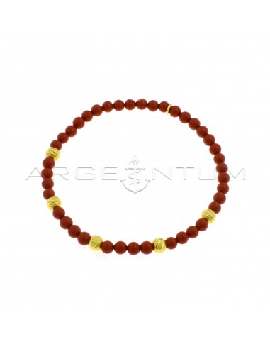 Elastic bracelet with coral paste spheres and transversal diamond spheres plated yellow gold in 925 silver