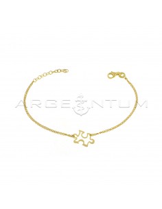 Double forced link bracelet with central puzzle piece in perforated plate yellow gold plated in 925 silver
