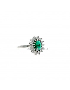 White gold plated ring with green oval stone 6x8 mm in a frame of white zircons with claws in 925 silver (Size 18)