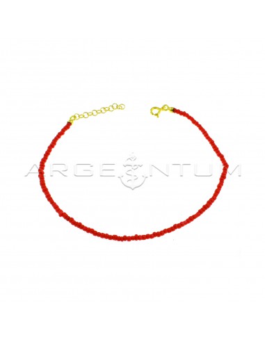 Red resin tube anklet with yellow gold plated terminals, closure and extension in 925 silver