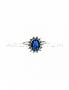 White gold plated ring with blue oval stone 6x8 mm in a frame of white zircons with claws in 925 silver (Size 10)