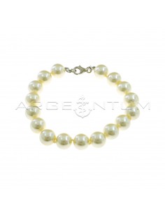 Bracelet of ø 10 mm pearls strung in knots with white gold plated terminals and snap hook in 925 silver