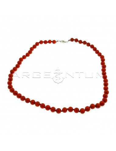 Ball necklace in coral paste ø 6 mm threaded in knots with white gold plated terminals and snap hook in 925 silver (Length 40 cm)