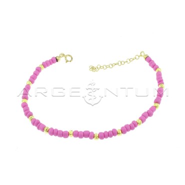 Anklet with fuchsia resin tubes and yellow gold plated diamond spheres in 925 silver