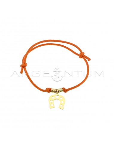 Orange colored cord bracelet with...