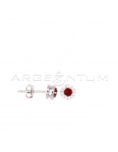 Stud earrings with central red zircon...